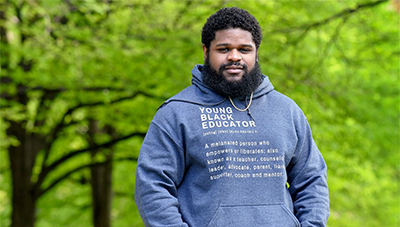 "Heinz Fellow Christopher Darby wearing a "Young Black Educator" hoodie"